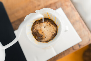 Drip coffee,Pouring a hot water over a drip coffee on the table