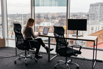 23.11.2018 Kyiv, Ukraine: portrait of a young girl working on a laptop sitting in a modern coworking space