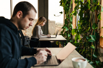 photo of young people working at a computer in a modern coworking office