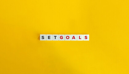 Set Goals Phrase on Letter Tiles on Yellow Background. Minimal Aesthetics.