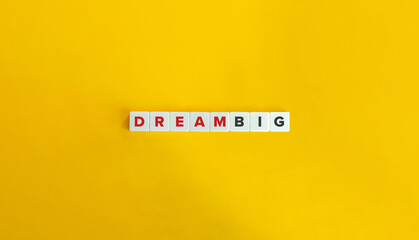 Dream Big Phrase on Letter Tiles on Yellow Background. Minimal Aesthetics.