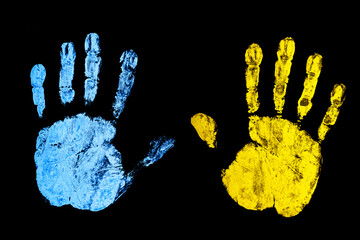 Ukraine flag color. Stop the war background. Open hand paint imprint. Symbolic gesture of STOP. One hand supporting another. Palm isolated on black.