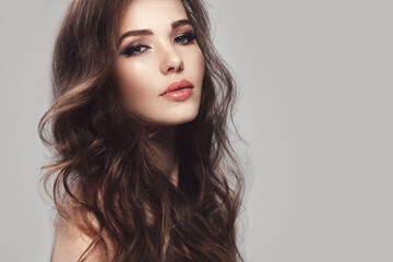 Beautiful young woman with long wavy hair