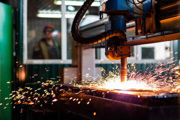 CNC laser plasma. Selective focus on modern technology laser plasma cutting of metal in process at metalworking factory male worker on background copyspace - obrazy, fototapety, plakaty