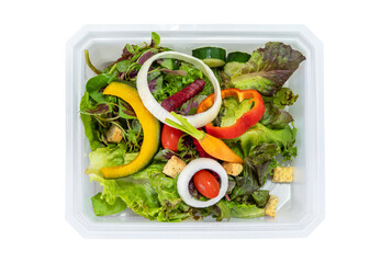 Green salad with fresh vegetables on white plastic food container for take home isolated on white background.