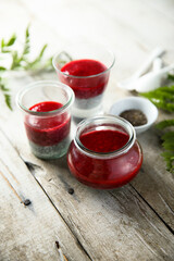 Panna cotta or chia pudding with red berry sauce