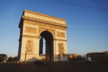 Fototapeta na wymiar Arch of Triumph building from Paris, France, during a beautiful spring sunrise. Photo taken from Champs Elysee boulevard. Landmarks of France.
