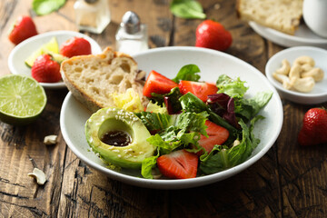 Healthy leaf salad with strawberry and avocado
