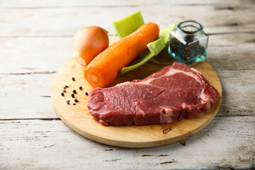 Beef broth ingredients on a wooden desk