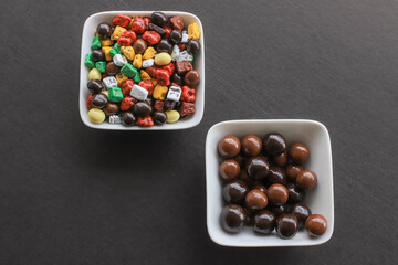 Small colored chocolates. Glazed chocolate. Sweet dragee stones. Desserts for Candy Bar. Small multi-colored candies.