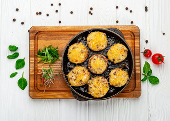 Stuffed champignons baked with cheese.