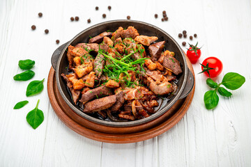 Meat and vegetables in frying pan