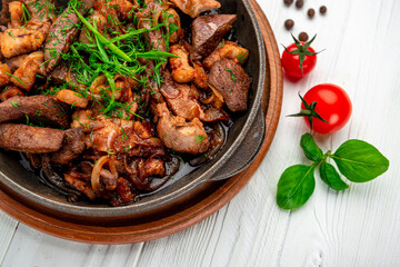 Meat and vegetables in frying pan