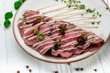Marbled beef carpaccio with arugula, lemon and parmesan cheese.