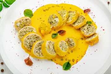 Stuffed squid with rice and vegetables with cheese sauce