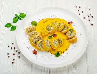 Stuffed squid with rice and vegetables with cheese sauce