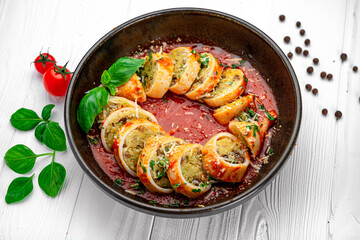 Squid stuffed with rice and vegetables in tomato sauce