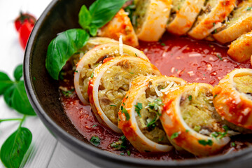 Squid stuffed with rice and vegetables in tomato sauce