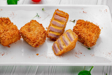Deep fried ham with cream cheese sauce