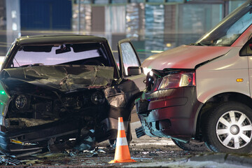 Cars crashed heavily in road accident after collision on city street at night. Road safety and...