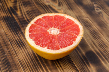 Fototapeta na wymiar Cut grapefruit half on wooden table.
