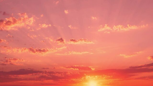 Amazing Pink Coral Orange Sunset with Sun Glare and Sunbeams in Pink Sky with Light Clouds, Time Lapse. Sun Beautifully Sets Horizon in the Field, Timelapse, Sunlight.