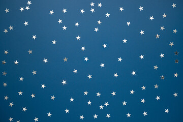 Fototapeta na wymiar blue background with silver stars confetti. Night sky minimalism concept. Clean background for web banner