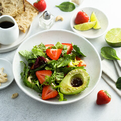 Healthy leaf salad with strawberry and avocado