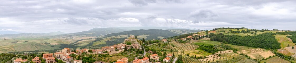 Fototapeta na wymiar Super panoramic view of Tuscany hills with medieval town Castiglione d'Orcia. Italy