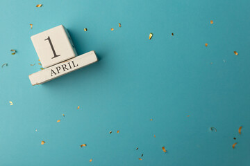 April 1st. Image of april 1 wooden calendar on blue background. Spring day, empty space for text. All Fool's Day