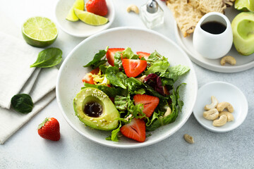 Healthy leaf salad with strawberry and avocado