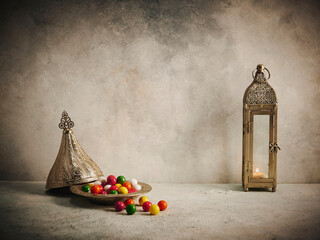 Ramadan concept, candy in the zinc plate Arabic style, lamp and Islamic background.