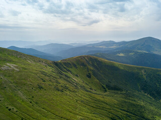 High mountains of the Ukrainian Carpathians in cloudy weather. Aerial drone view.