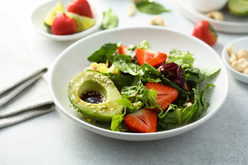 Healthy leaf salad with strawberry and avocado