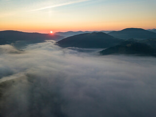 Sunrise over the fog in the Ukrainian Carpathians. Aerial drone view.