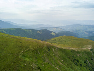 Naklejka premium High mountains of the Ukrainian Carpathians in cloudy weather. Aerial drone view.