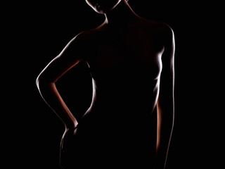 Nude Woman silhouette in the dark