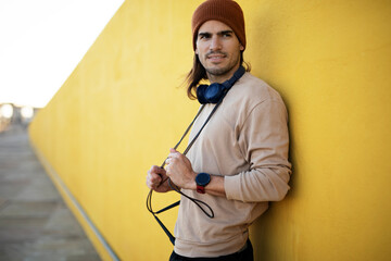 Young muscle man training outside. Fit handsome man relaxing after training