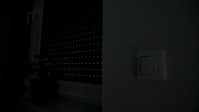 Man push switch button and automatic roller shutter open on window, Home protection