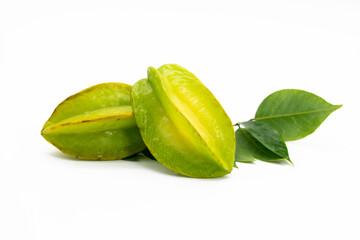 Raw carambolas or Star fruit with green leaves on white background