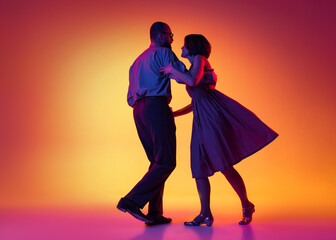 Portrait of excited man and woman, couple of dancers in vintage retro style outfits dancing lindy...