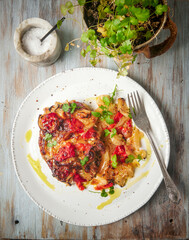 Pork chops with onion, bell peppers and cheese