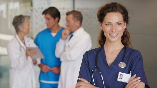 Portrait of successful nurse with team