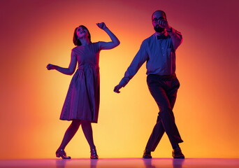 Portrait of excited man and woman, couple of dancers in vintage retro style outfits dancing lindy...