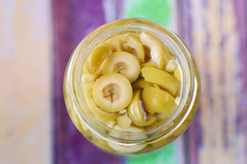 slice of a olive in a jar top view 