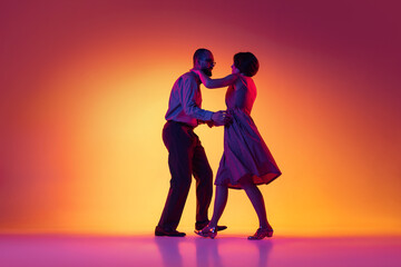 Portrait of excited man and woman, couple of dancers in vintage retro style outfits dancing lindy...