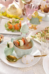 Easter white borscht with quail egg and sausage skewer