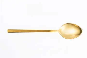 Foto op Plexiglas close-up of gold spoon on white background © noowans