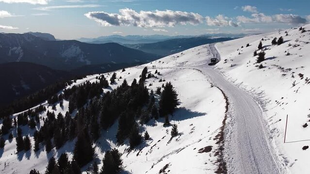 Aerial panoramic view of a snow covered road, on the italian Alp mountains, in winter