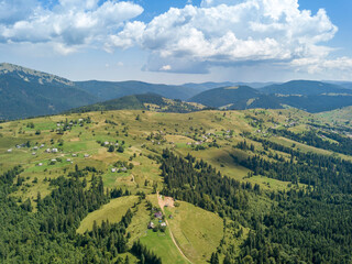 Fototapeta premium Green mountains of Ukrainian Carpathians in summer. Sunny day. Aerial drone view.